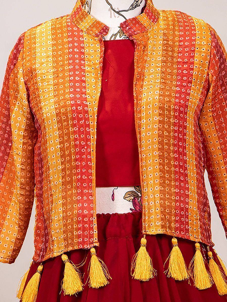 Orange and red printed ethnic jacket with tassels, paired with maroon lehenga choli for festive wear