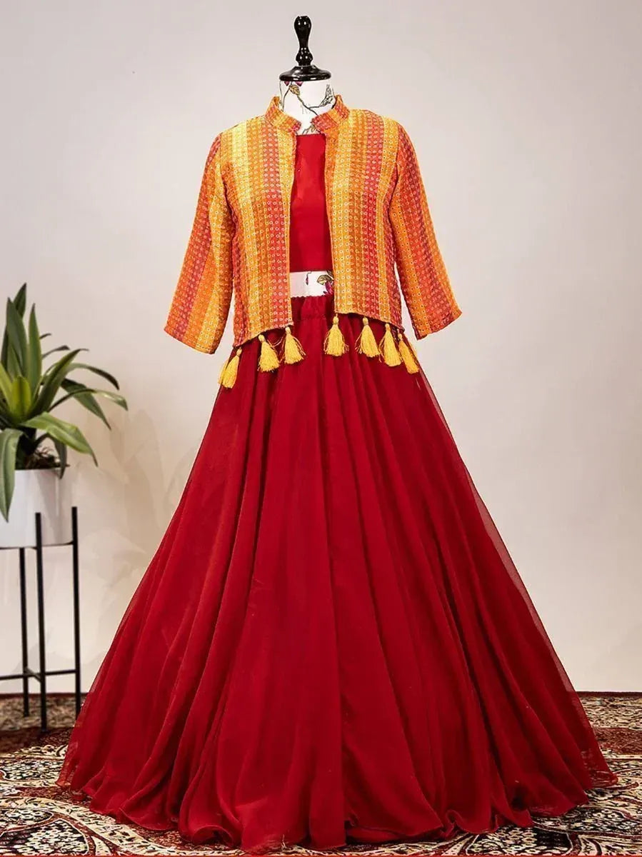 Red ethnic gown with orange patterned jacket and tassels, perfect for Indian celebrations