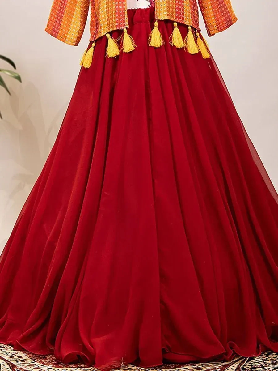 Red velvet lehenga with golden tassels and embroidered orange blouse, ethnic Indian wear