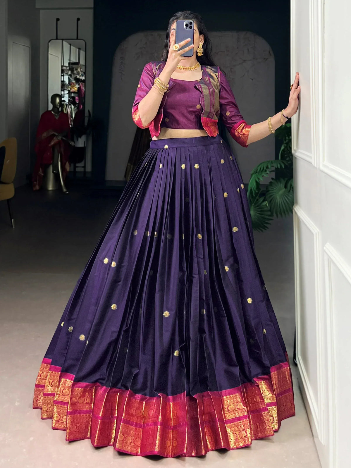 Purple lehenga choli with gold motifs and red border, styled for ethnic occasions
