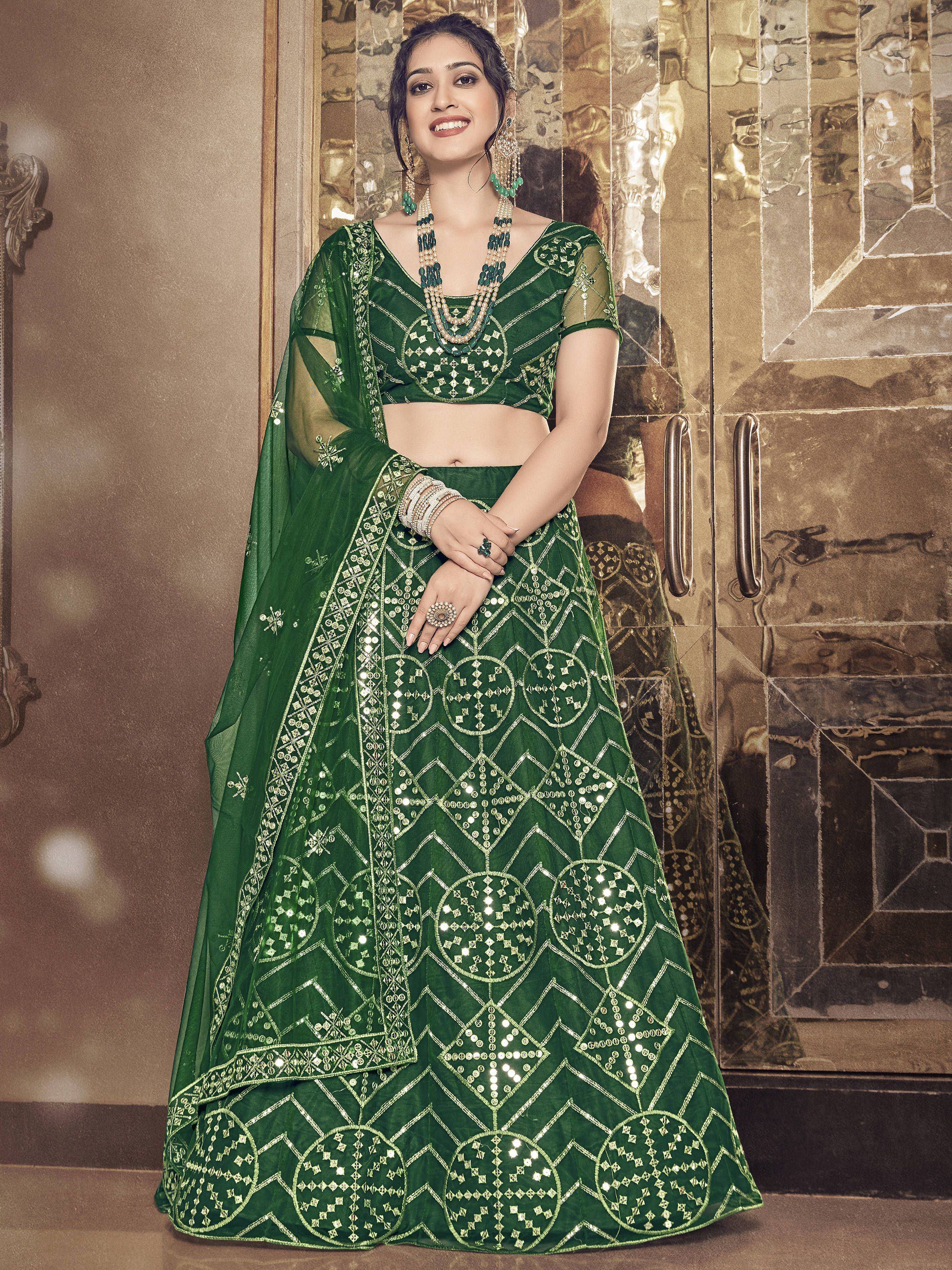 Green embroidered lehenga choli with mirror work and gold detailing, perfect for Indian ethnic wear.