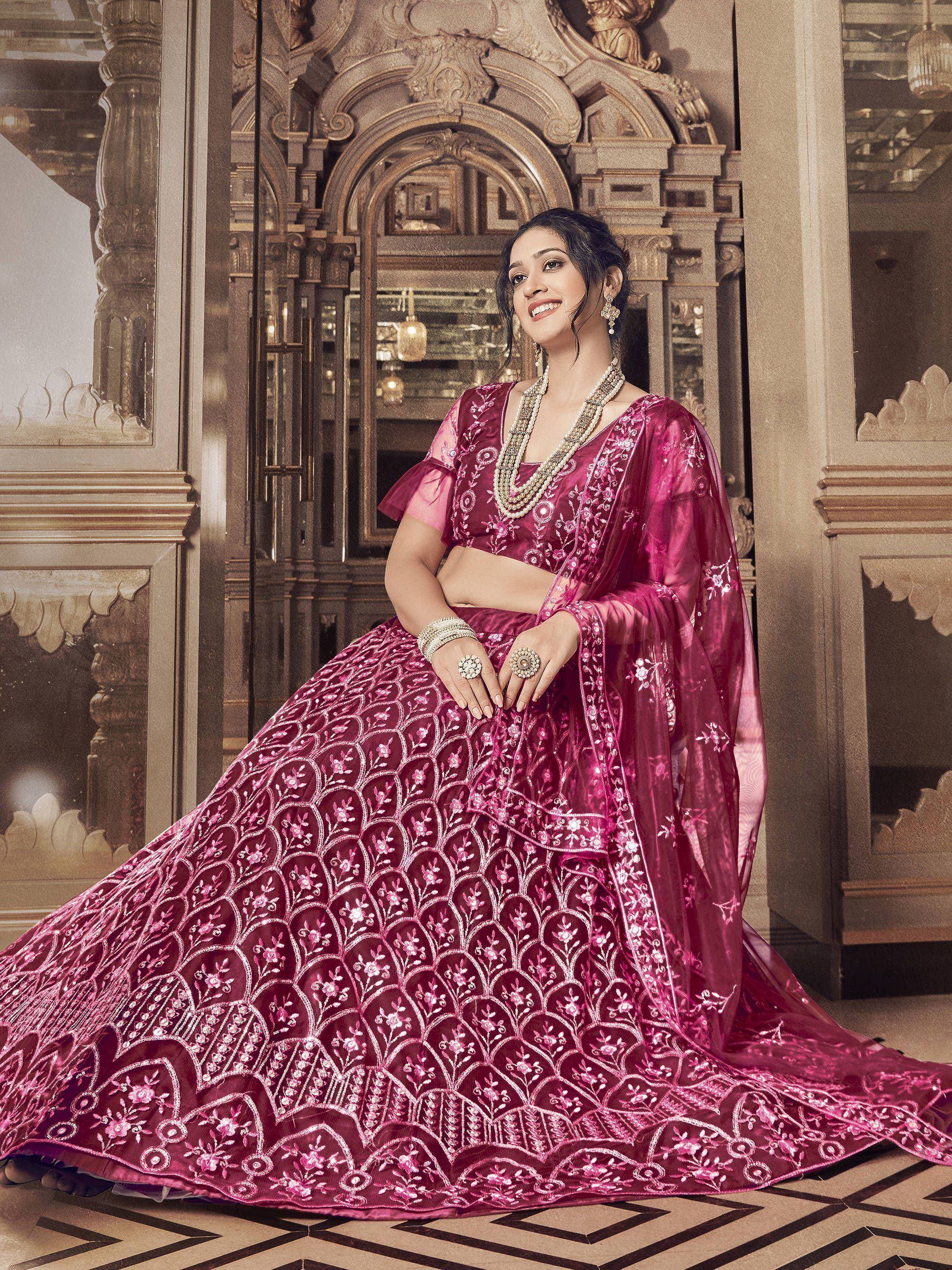 Elegant pink embroidered lehenga choli with floral motifs, perfect for Indian weddings and festive occasions.