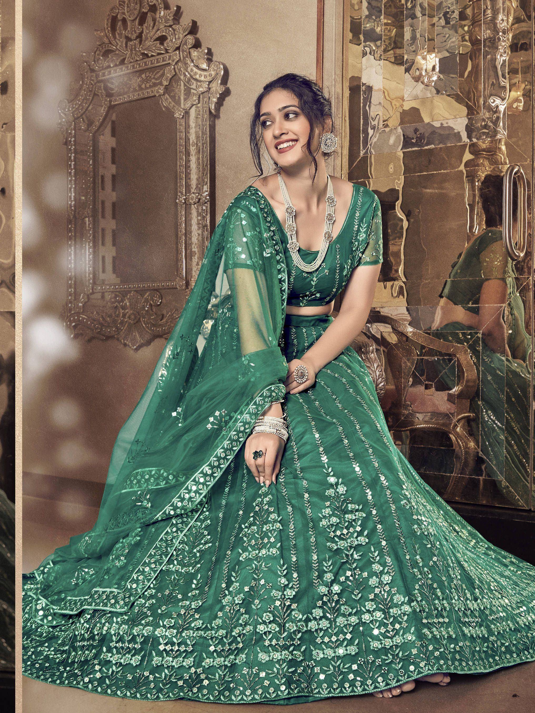 Emerald green designer lehenga choli with floral embroidery, perfect for Indian weddings and festive occasions.