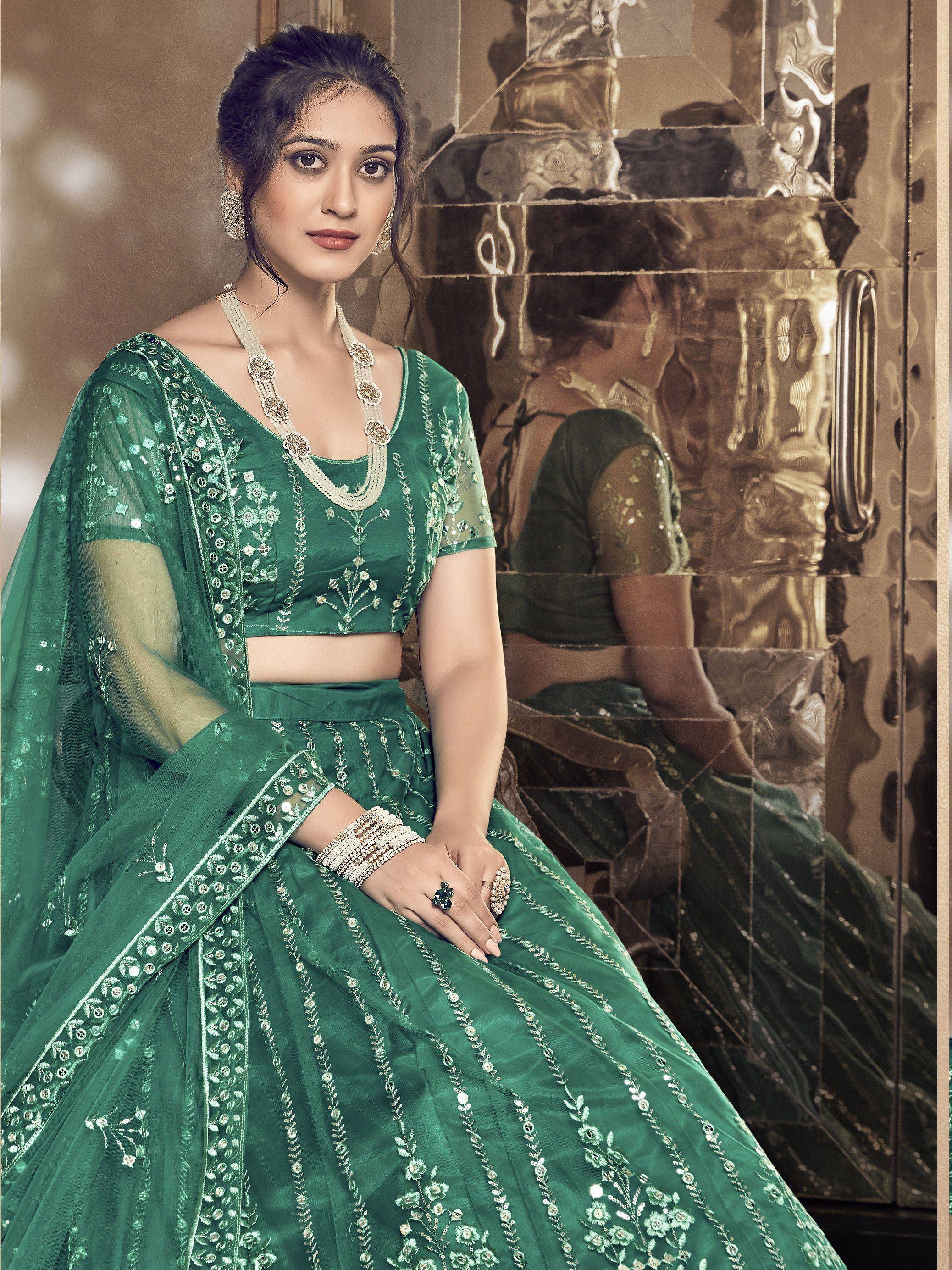 Emerald green designer lehenga choli with floral embroidery and sheer dupatta, perfect for Indian weddings and festive occasions.