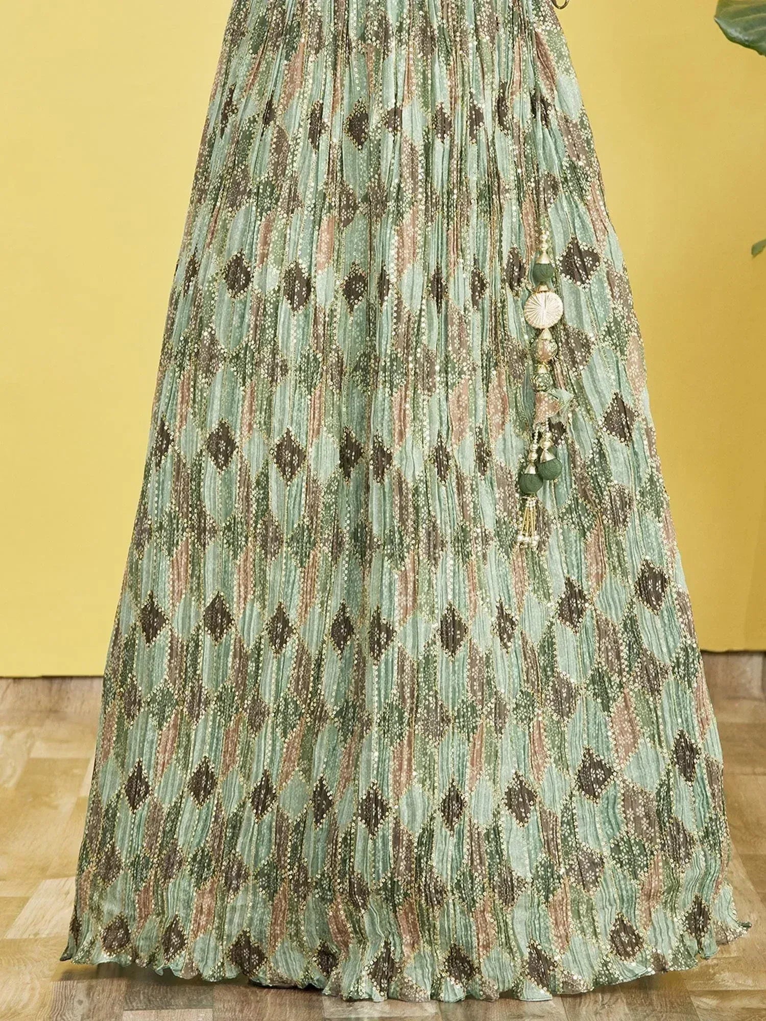 Green printed pleated lehenga with diamond pattern and tassel detail, ethnic Indian wear