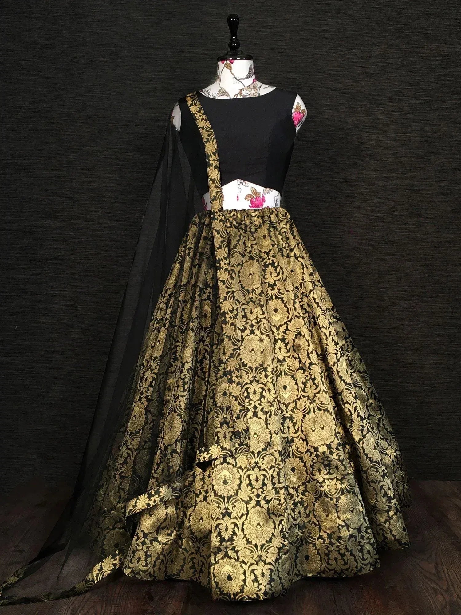 Black and gold designer lehenga choli with floral brocade skirt and sheer dupatta, ethnic Indian wear