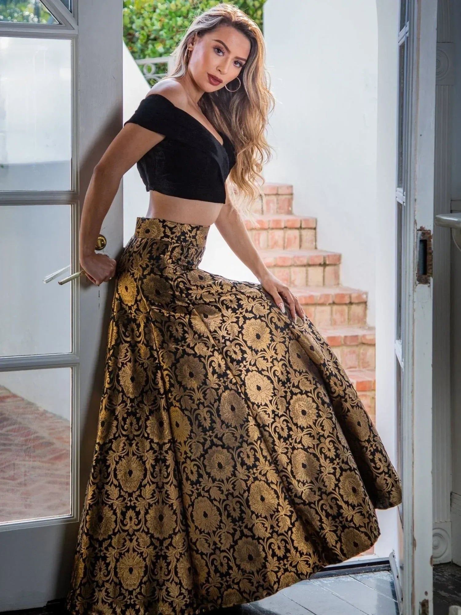 Black off-shoulder top with gold floral print lehenga skirt, ethnic wear for women