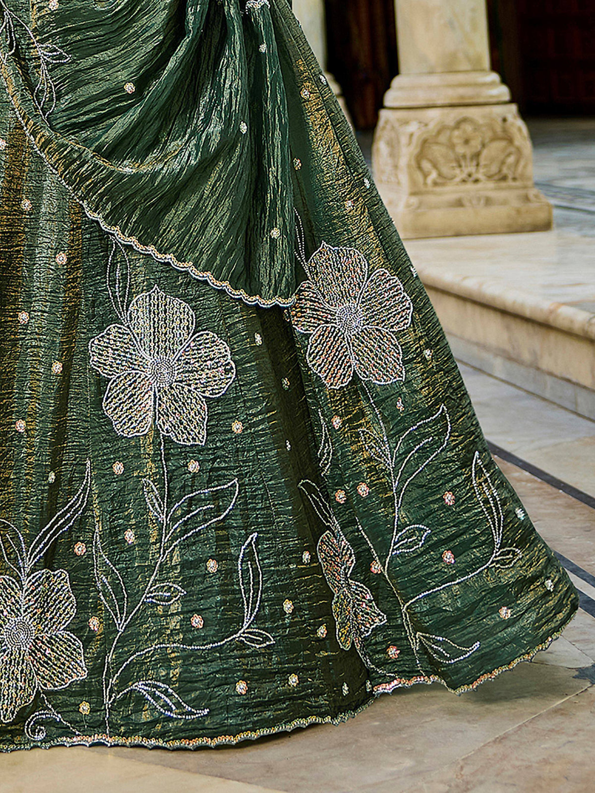 Emerald green lehenga with intricate floral embroidery and beadwork, perfect for Indian ethnic wear.