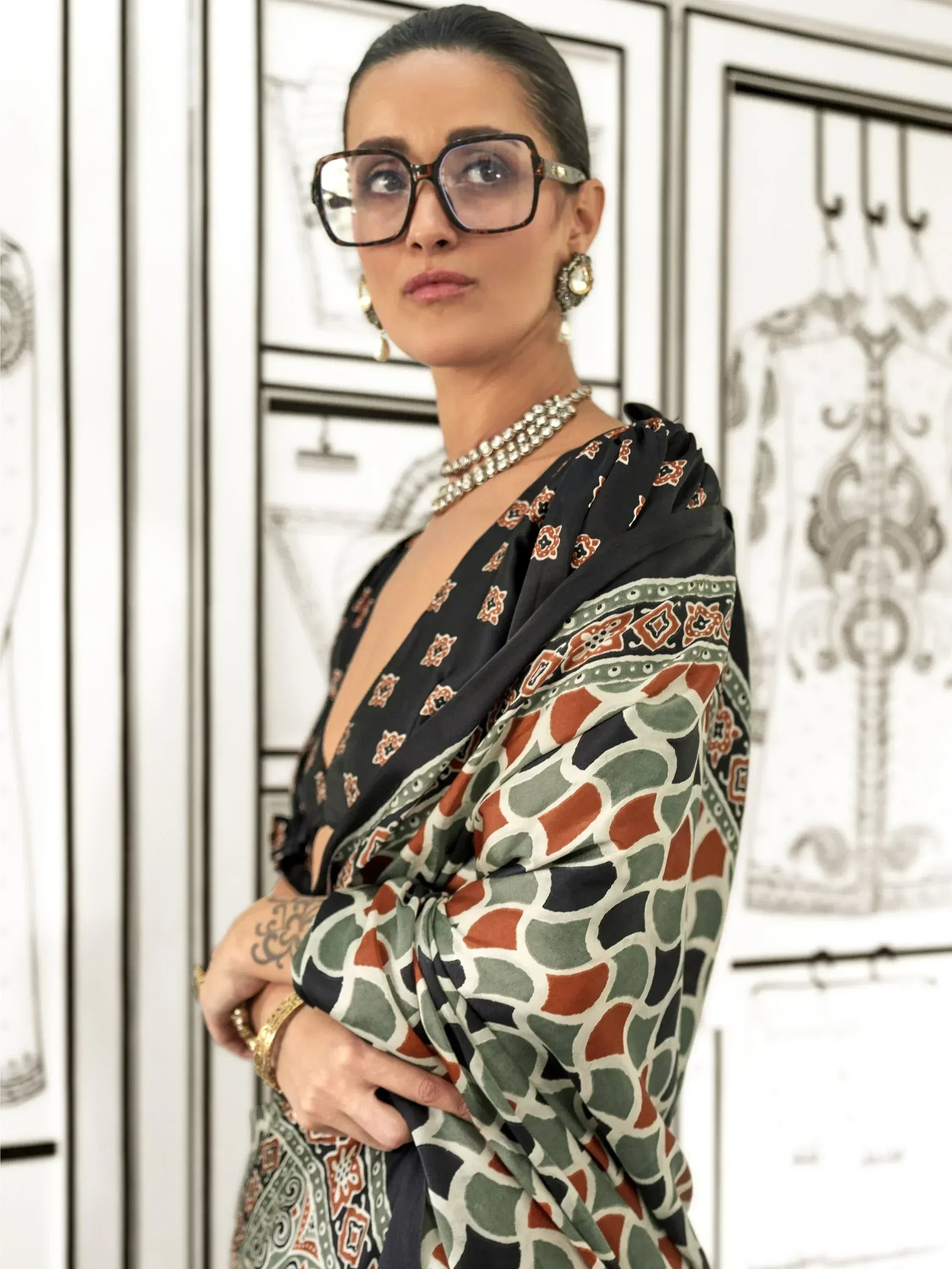 Woman in stylish printed saree with ethnic jewelry and bold glasses, perfect for Indian ethnic wear occasions
