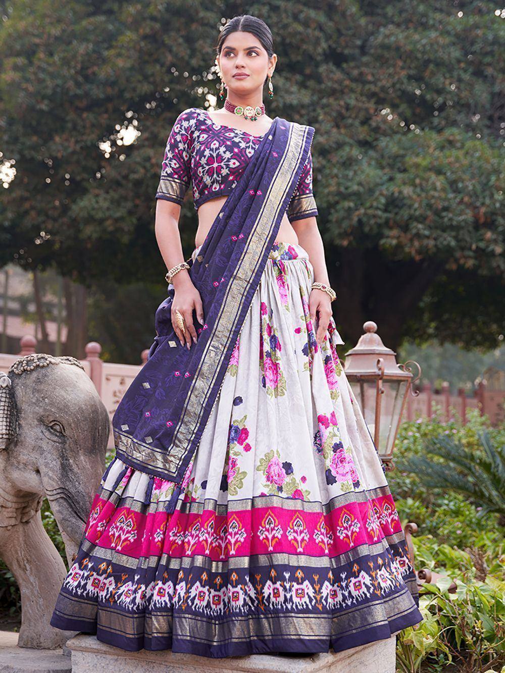 Woman in floral print lehenga choli with purple dupatta, ethnic Indian wear for festive occasions
