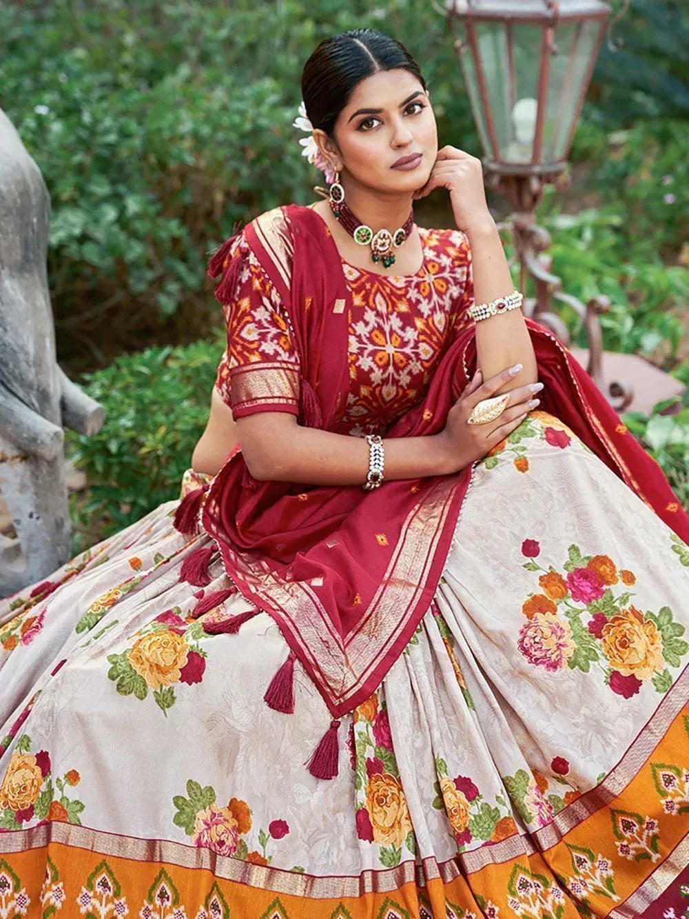 Woman in floral print lehenga choli with maroon dupatta, traditional Indian ethnic wear