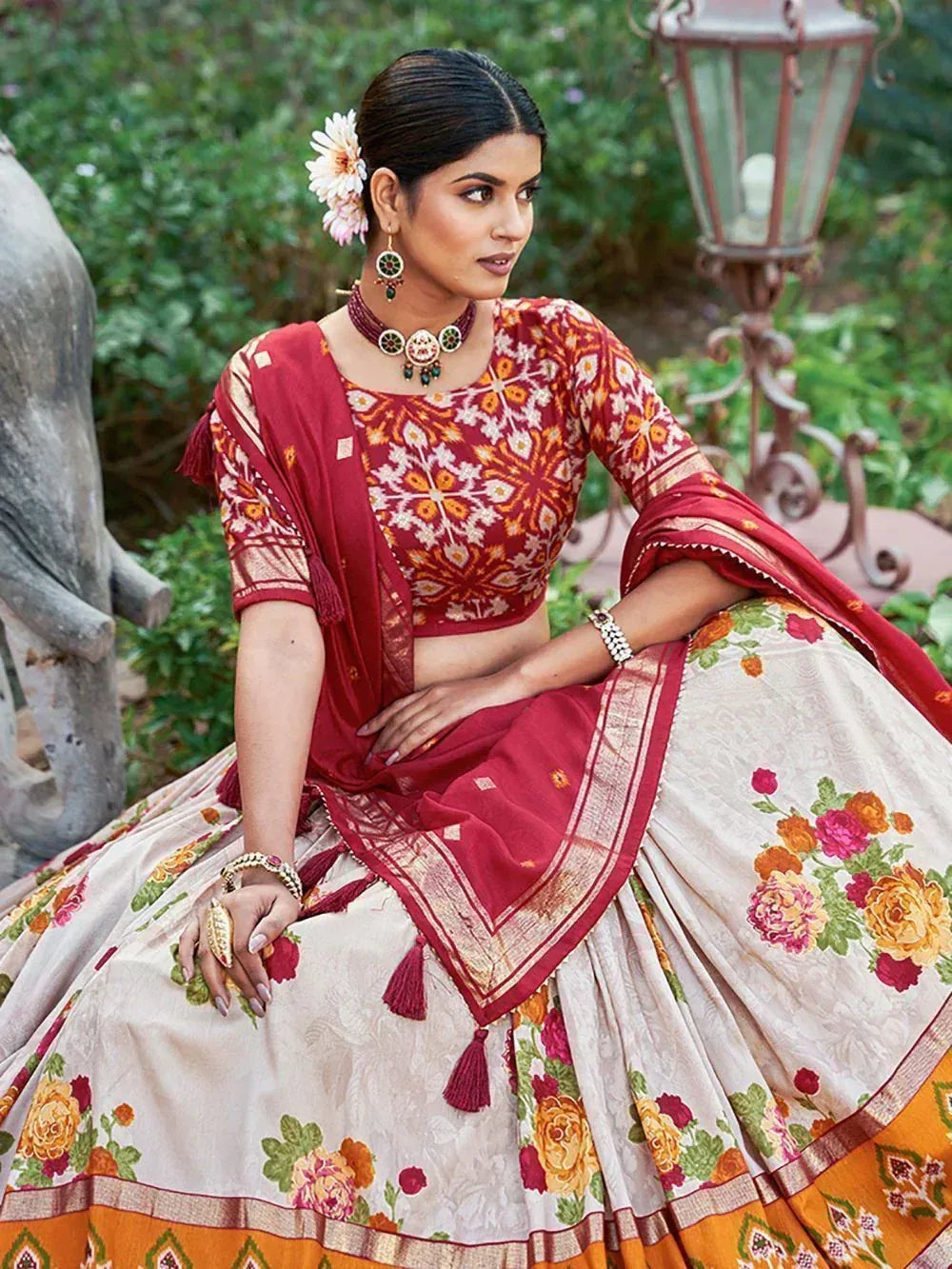 Woman in floral print lehenga choli with red dupatta, traditional Indian ethnic wear