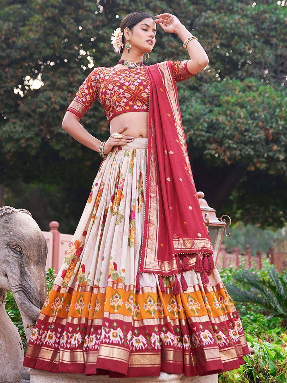 Woman in floral lehenga choli with red dupatta, ethnic Indian wear for festive occasions