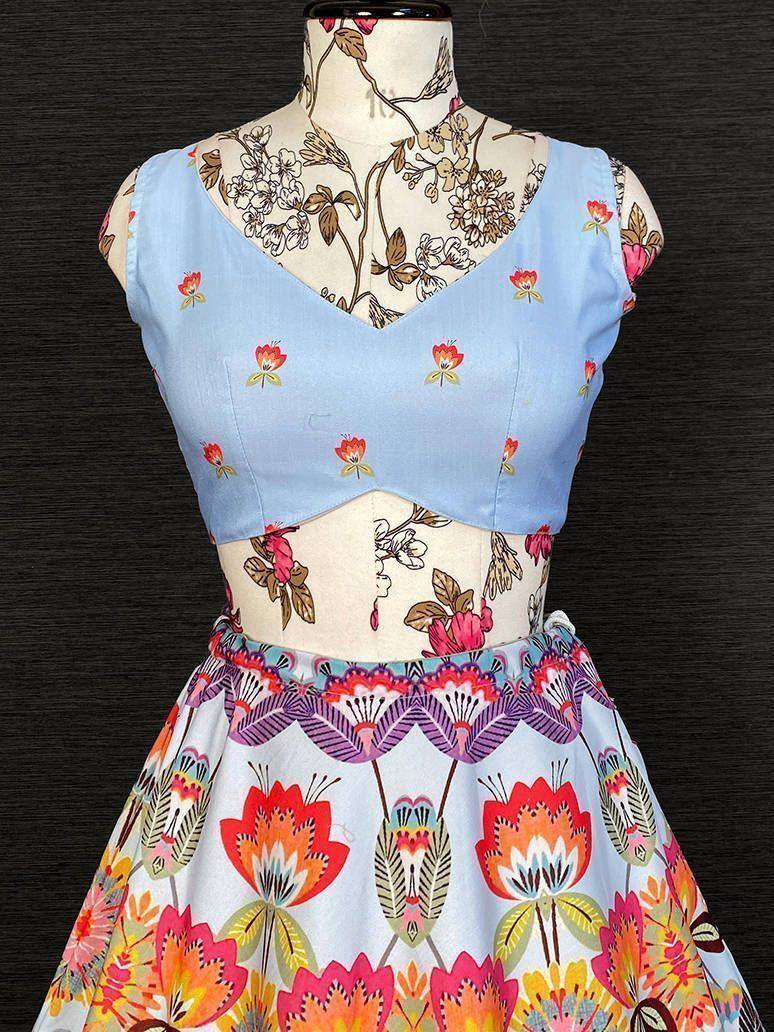 Light blue floral crop top with vibrant printed skirt, ethnic wear for women