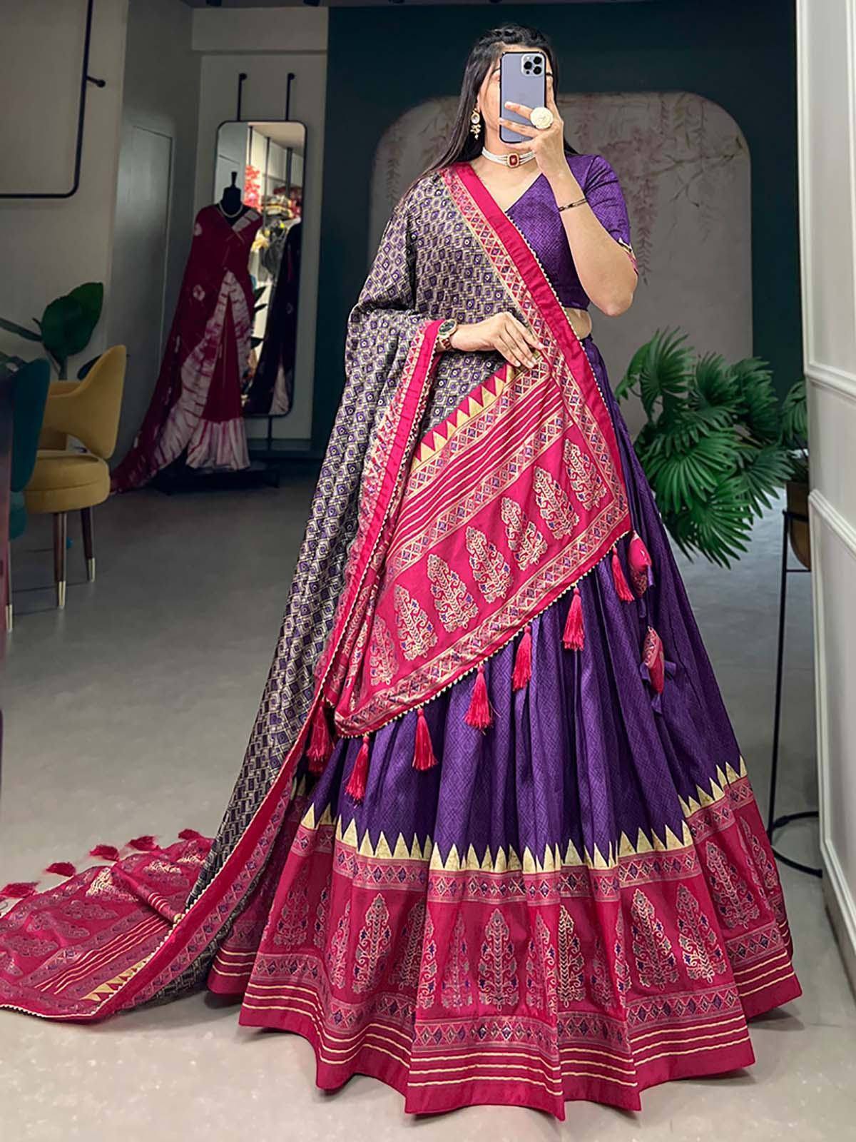 Purple and pink designer lehenga choli with intricate embroidery and tassels, perfect for Indian ethnic wear occasions