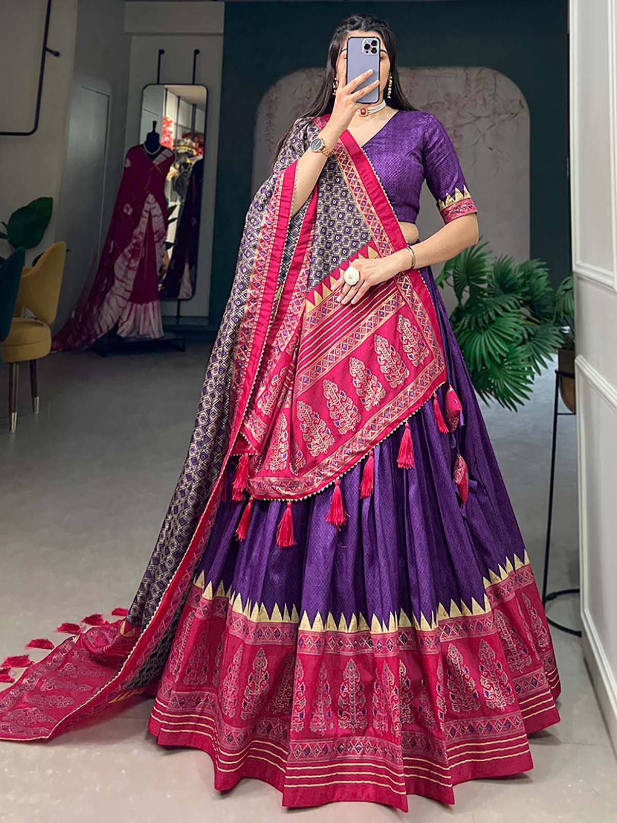 Purple and pink designer lehenga choli with intricate embroidery and tassels, perfect for Indian ethnic wear.
