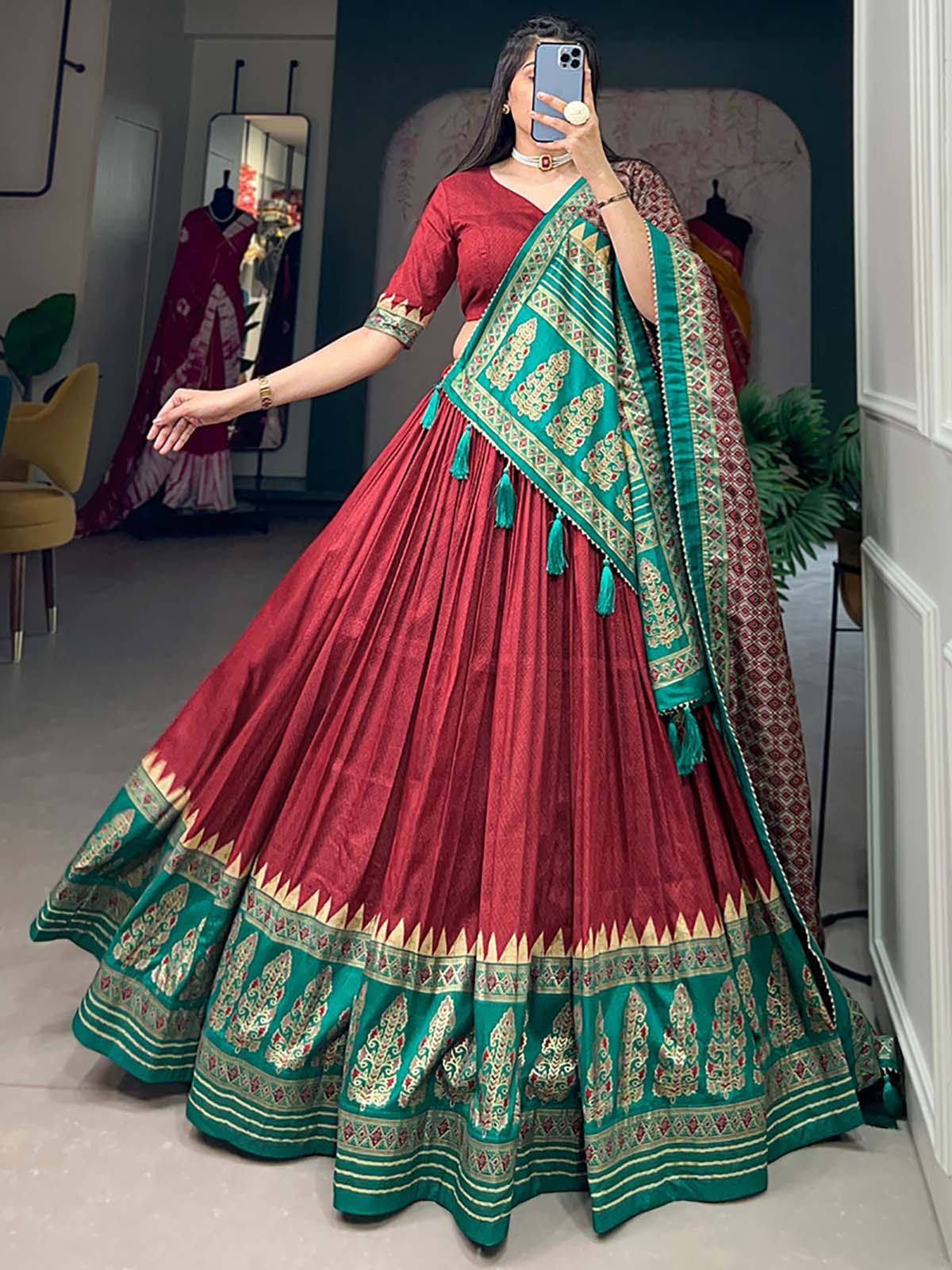 Red and green designer lehenga choli with intricate embroidery and tassels, perfect for Indian ethnic wear