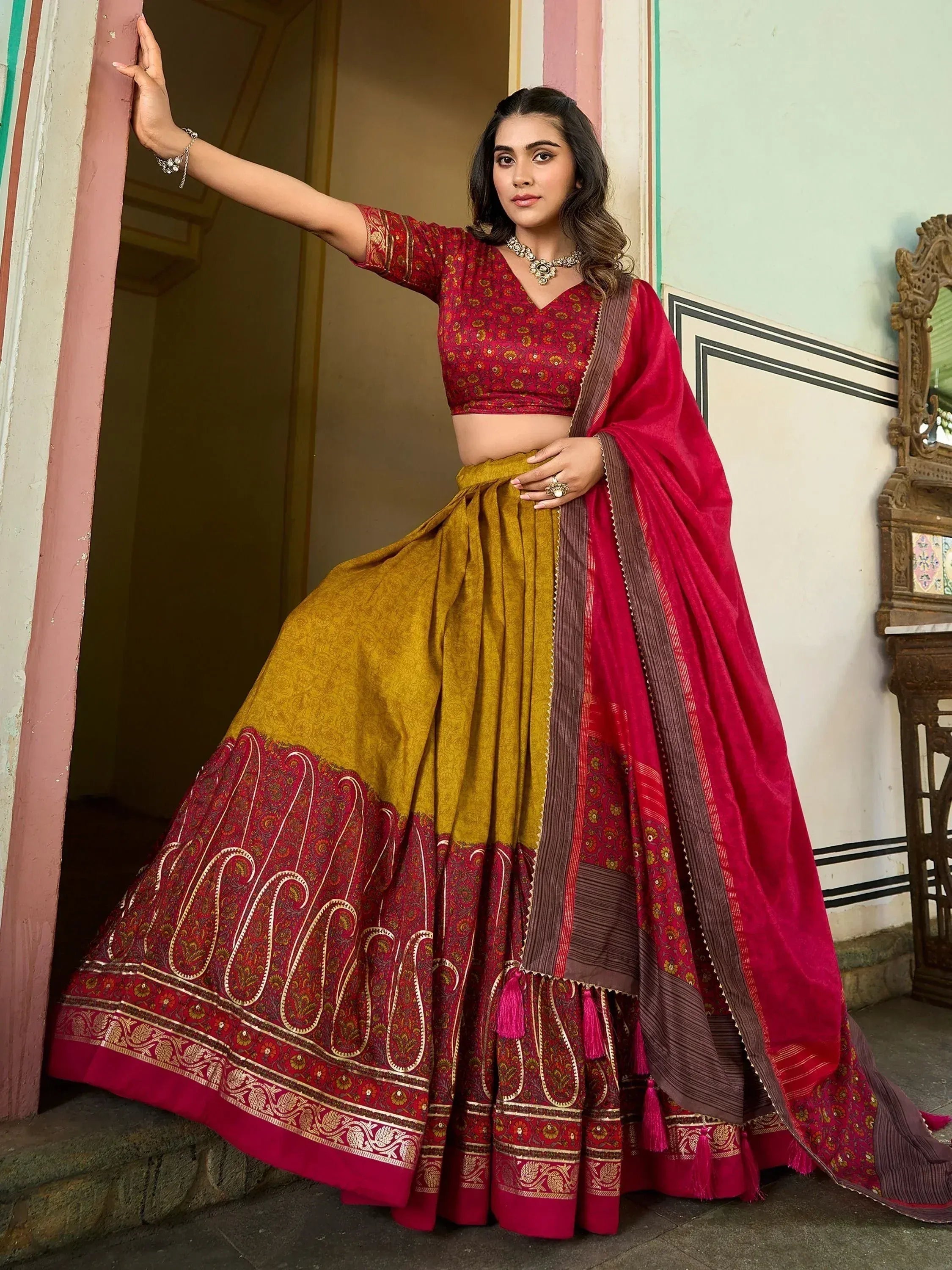 Red and mustard designer lehenga choli with intricate paisley border and dupatta, ethnic Indian wear