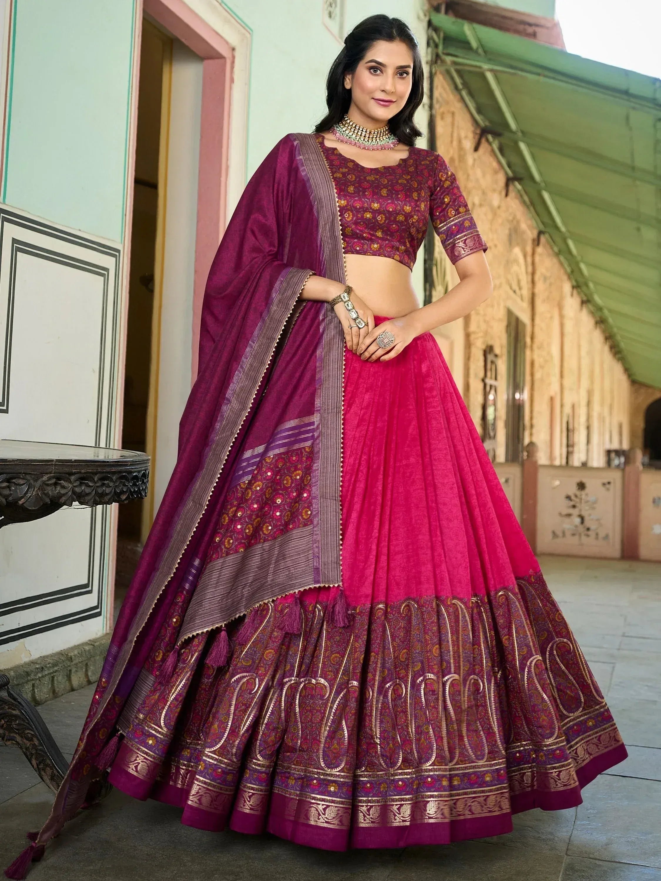 Elegant purple and pink lehenga choli with floral embroidery and paisley border, perfect for Indian ethnic occasions
