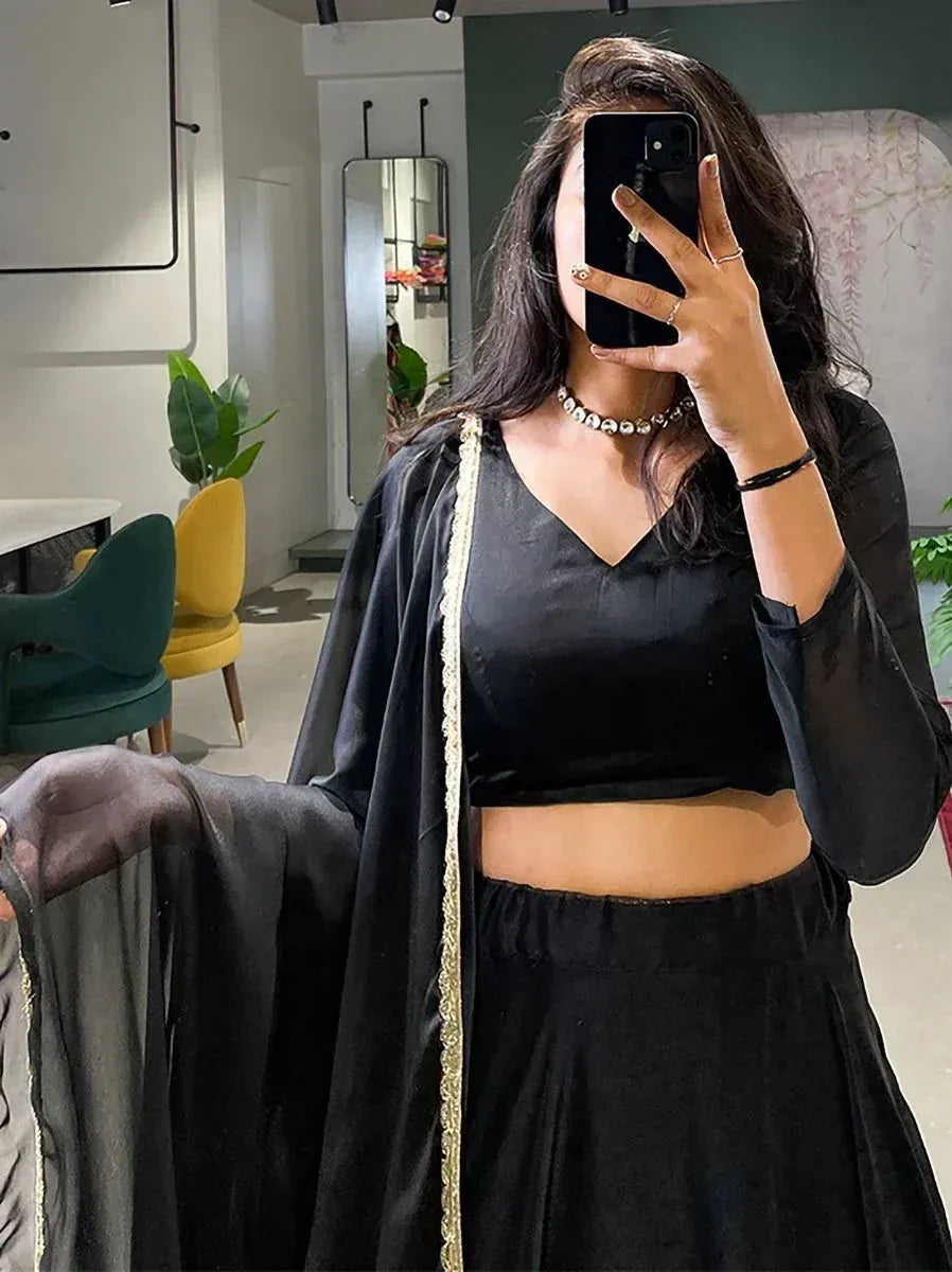 Black ethnic lehenga choli with gold trim, stylish Indian wear for women
