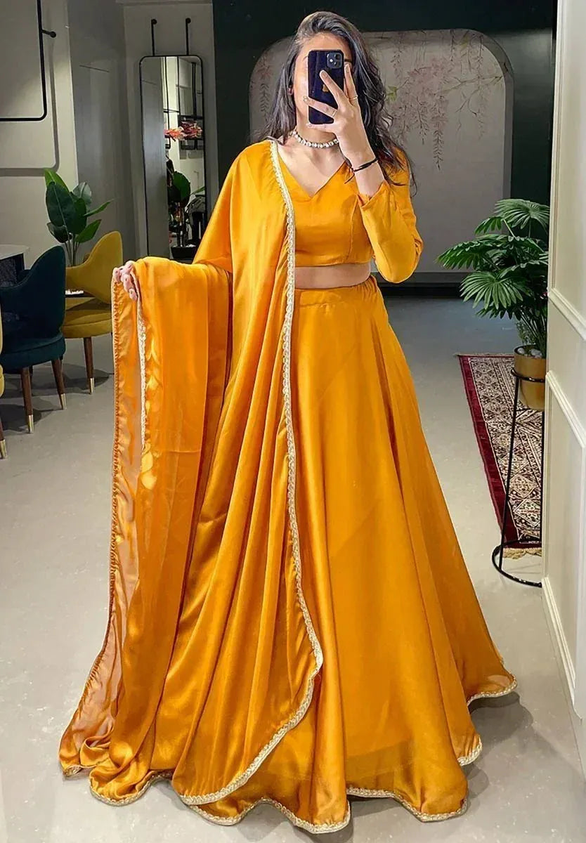 Mustard yellow designer lehenga choli with gold trim, perfect for weddings and festive occasions