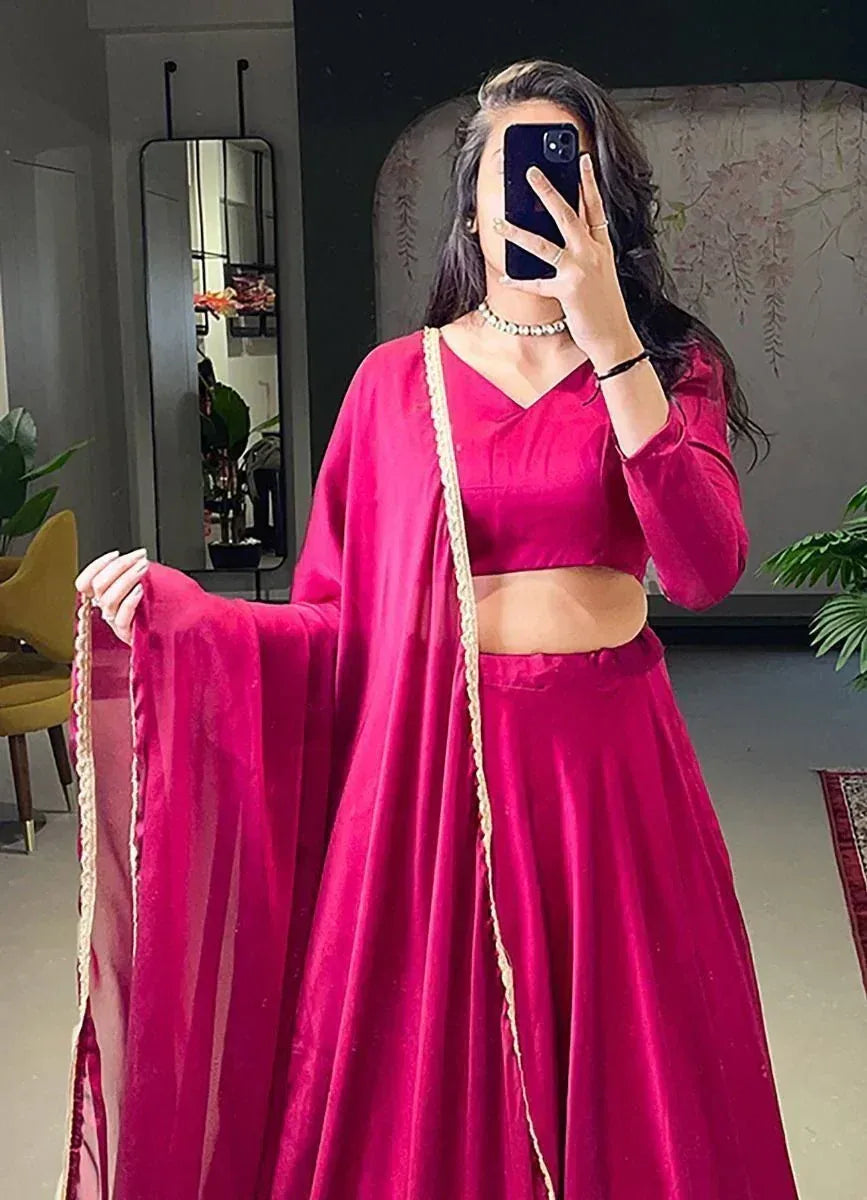 Fuchsia velvet lehenga choli with gold trim, perfect for Indian ethnic wear and festive occasions.