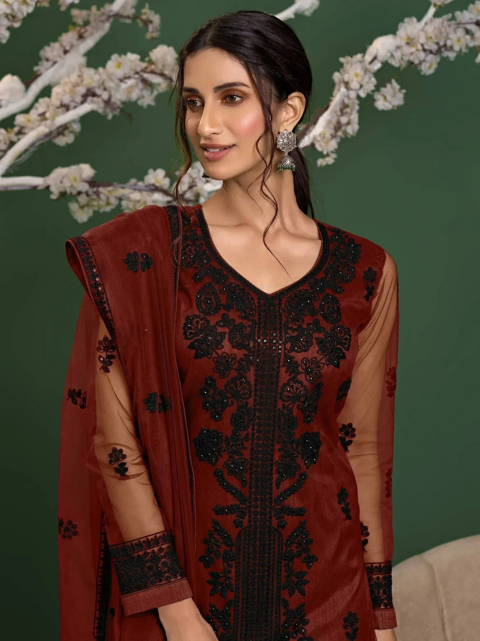 Elegant maroon salwar kameez with black floral embroidery and sheer sleeves, perfect for ethnic occasions.
