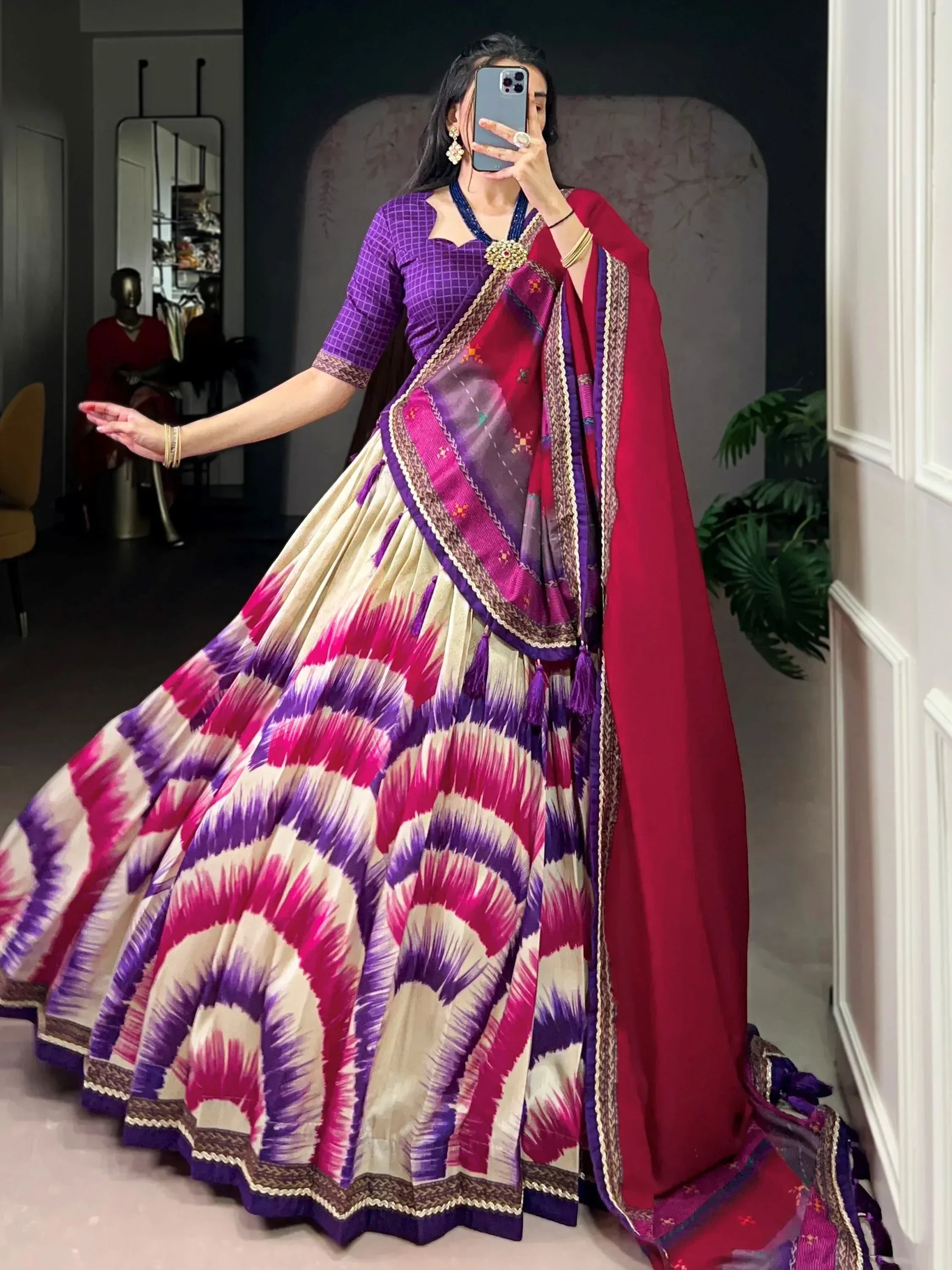 Vibrant purple and pink ikat lehenga choli with embroidered dupatta, perfect for ethnic occasions.