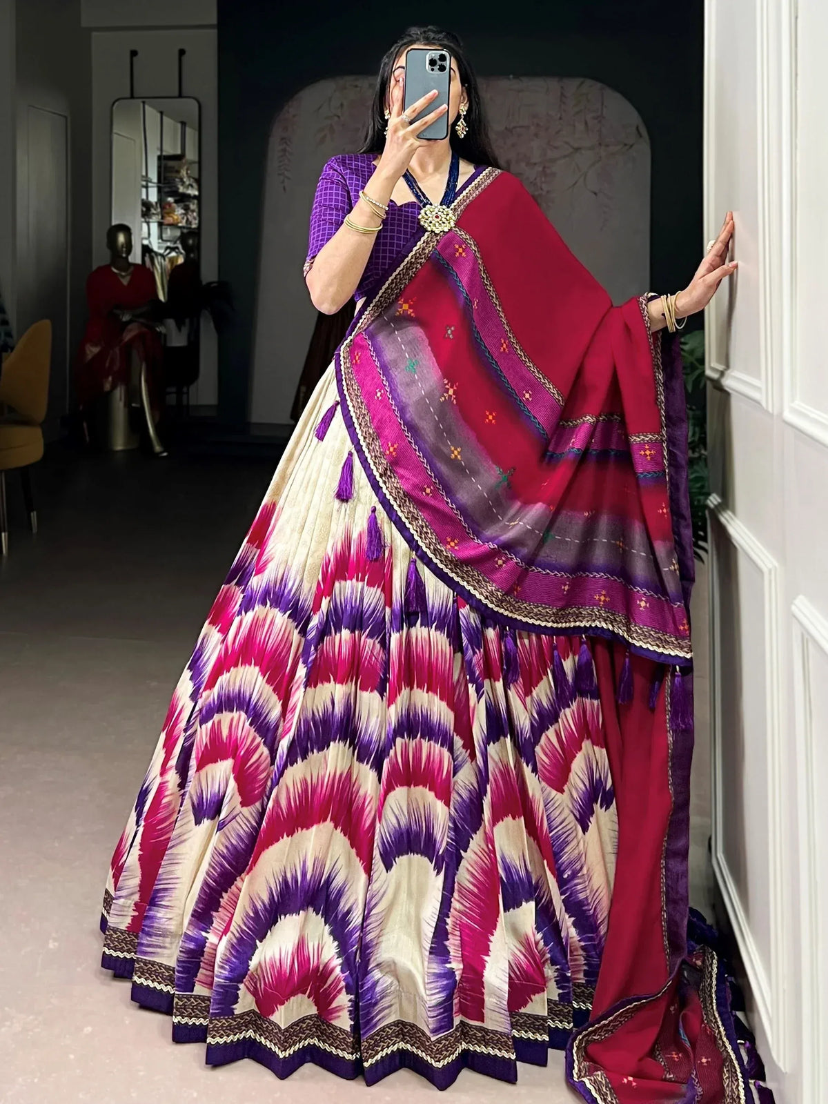 Vibrant purple and pink ikat lehenga choli with embroidered dupatta, perfect for ethnic occasions.