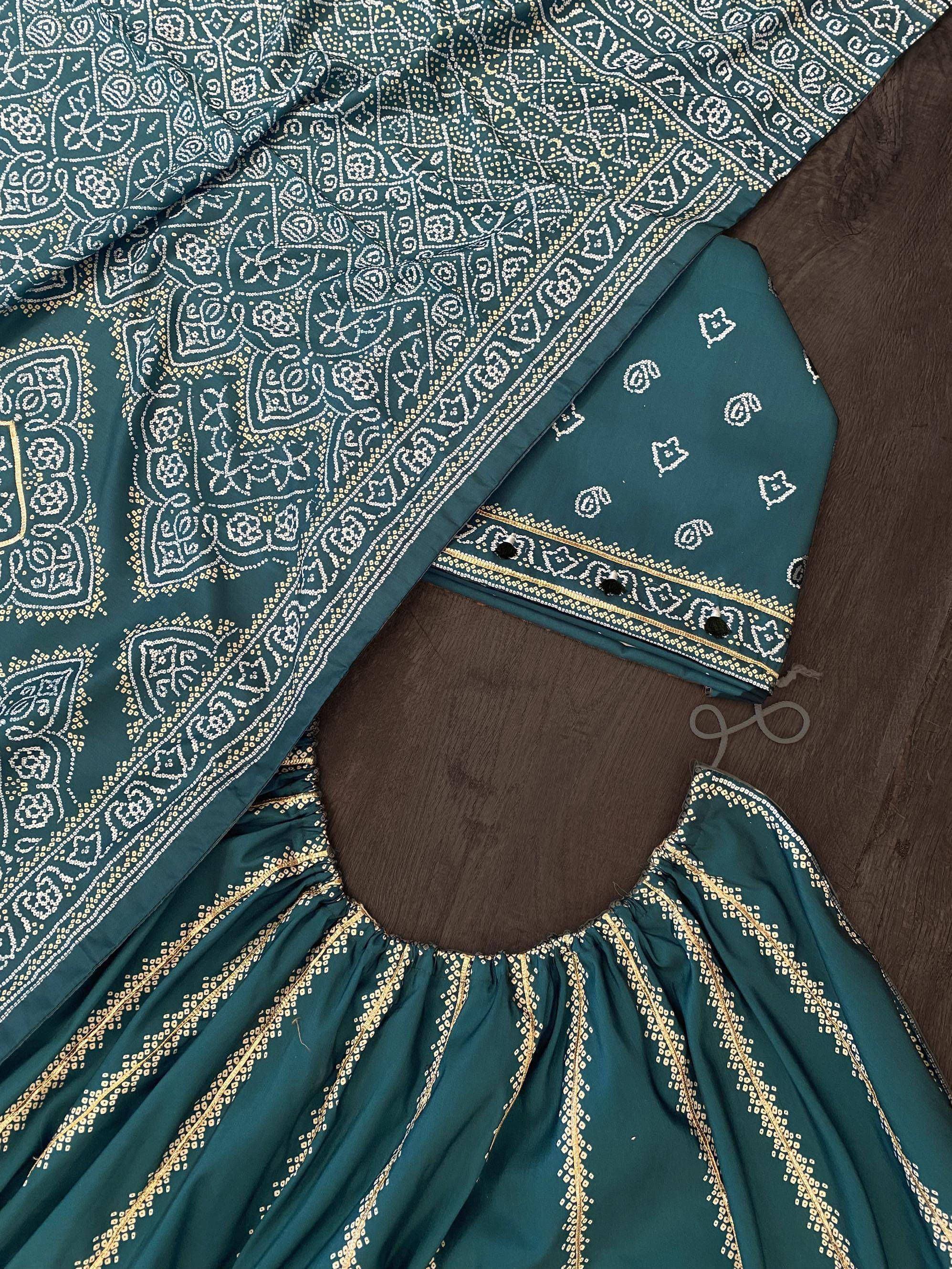 Teal ethnic lehenga choli with white and gold embroidery, perfect for Indian festive wear