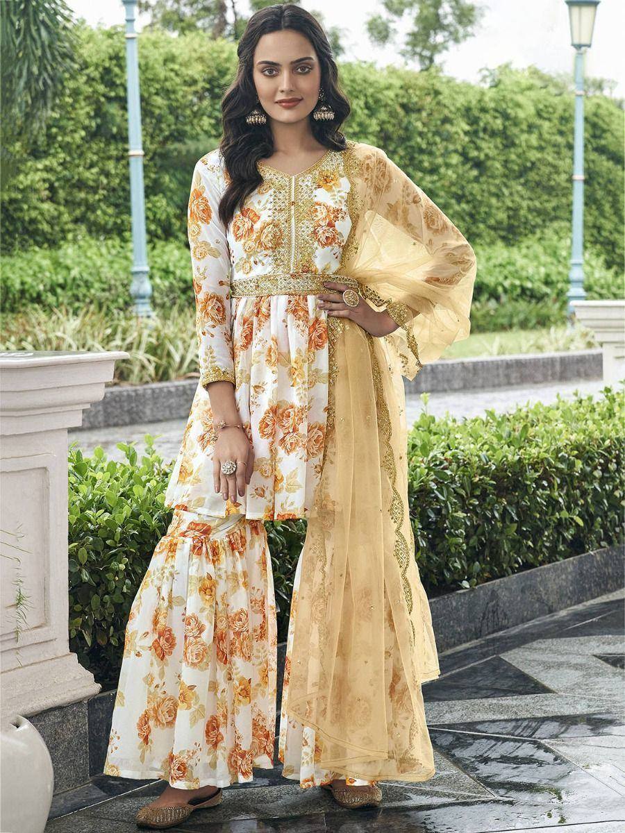 Floral print ethnic salwar kameez with gold embroidery and sheer dupatta, perfect for festive occasions