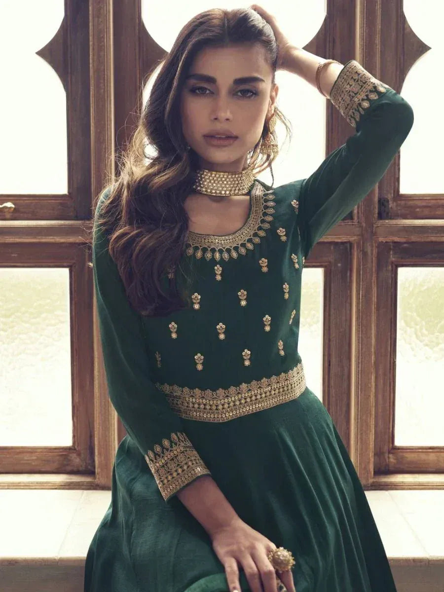 Emerald green ethnic gown with gold embroidery, perfect for Indian festive occasions and weddings.
