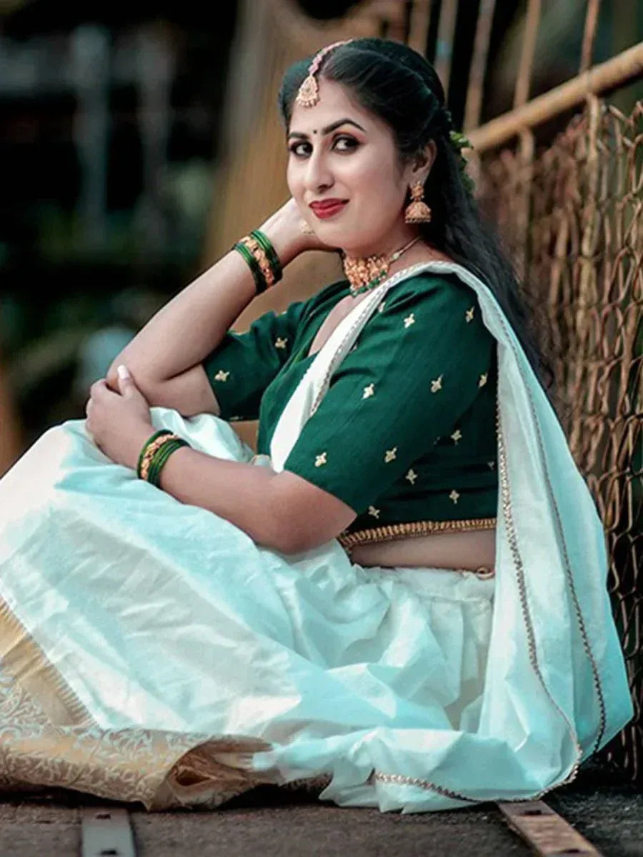 Woman in green embroidered blouse with light blue lehenga, traditional Indian ethnic wear