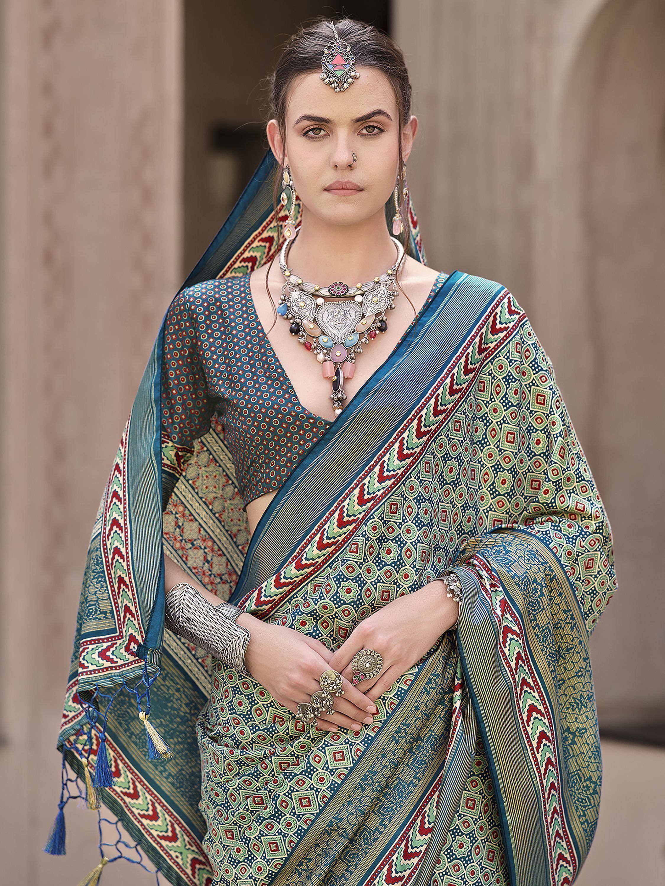 Woman in vibrant printed saree with ethnic jewelry, perfect for Indian festive occasions