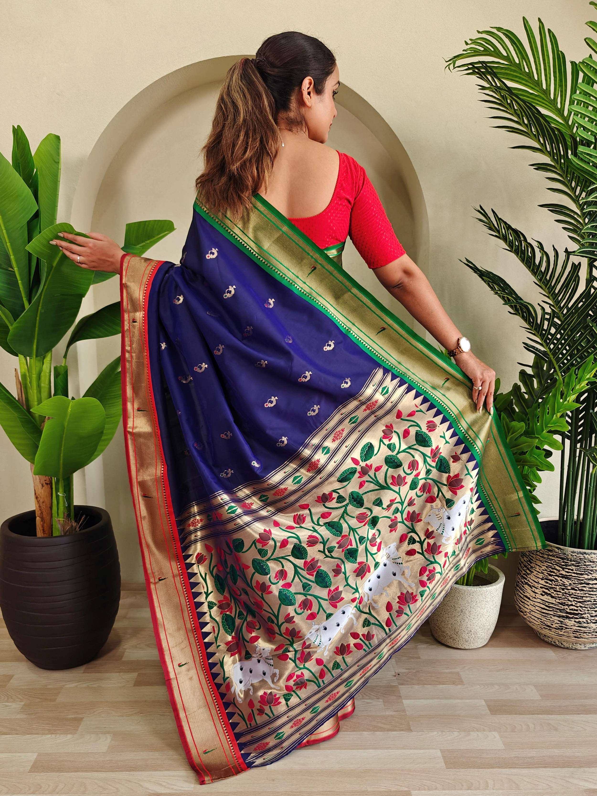 Woman in blue saree with floral and horse print, gold border, red blouse, ethnic wear