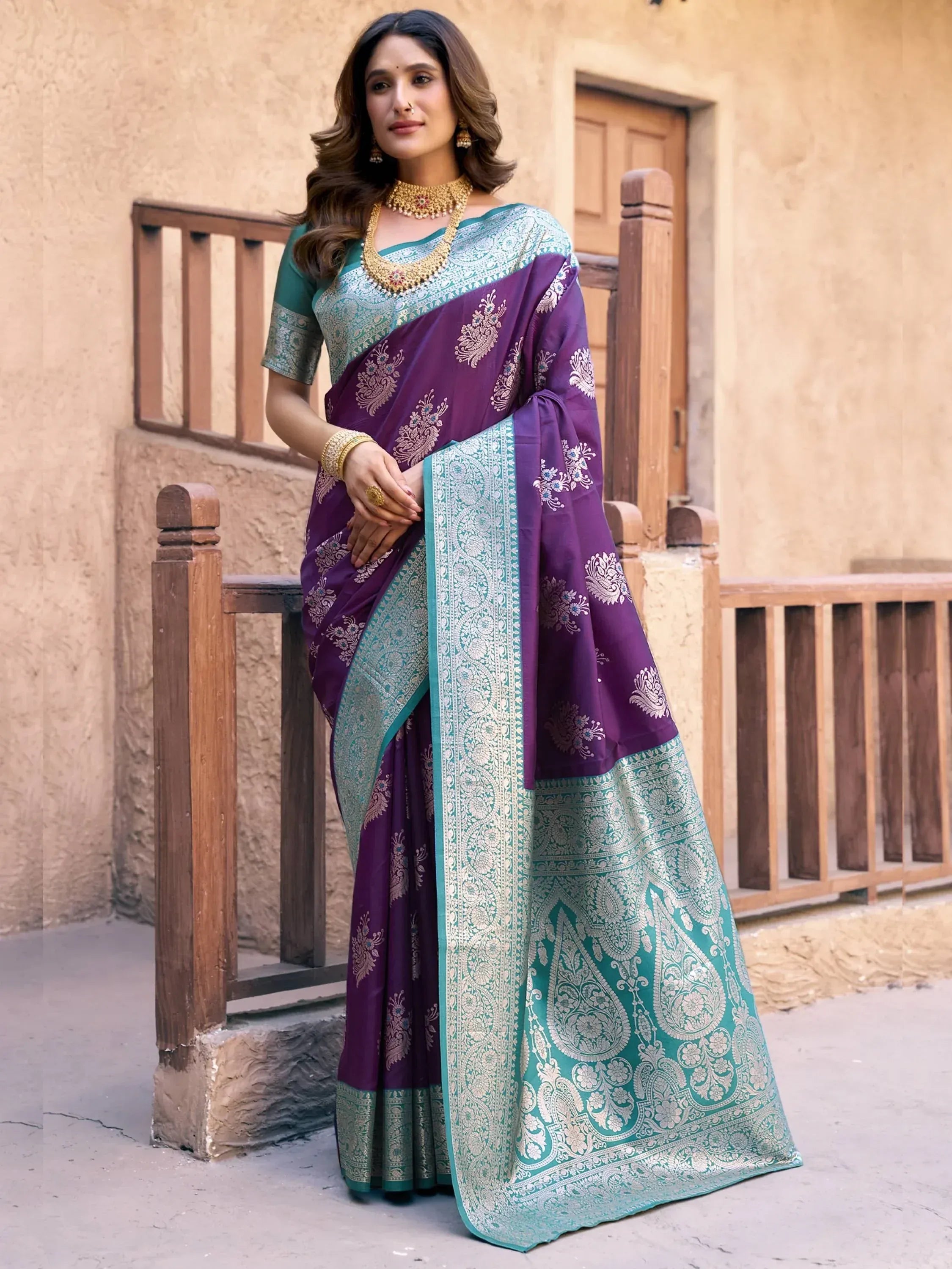 Purple and teal designer saree with intricate paisley embroidery, perfect for Indian ethnic occasions.