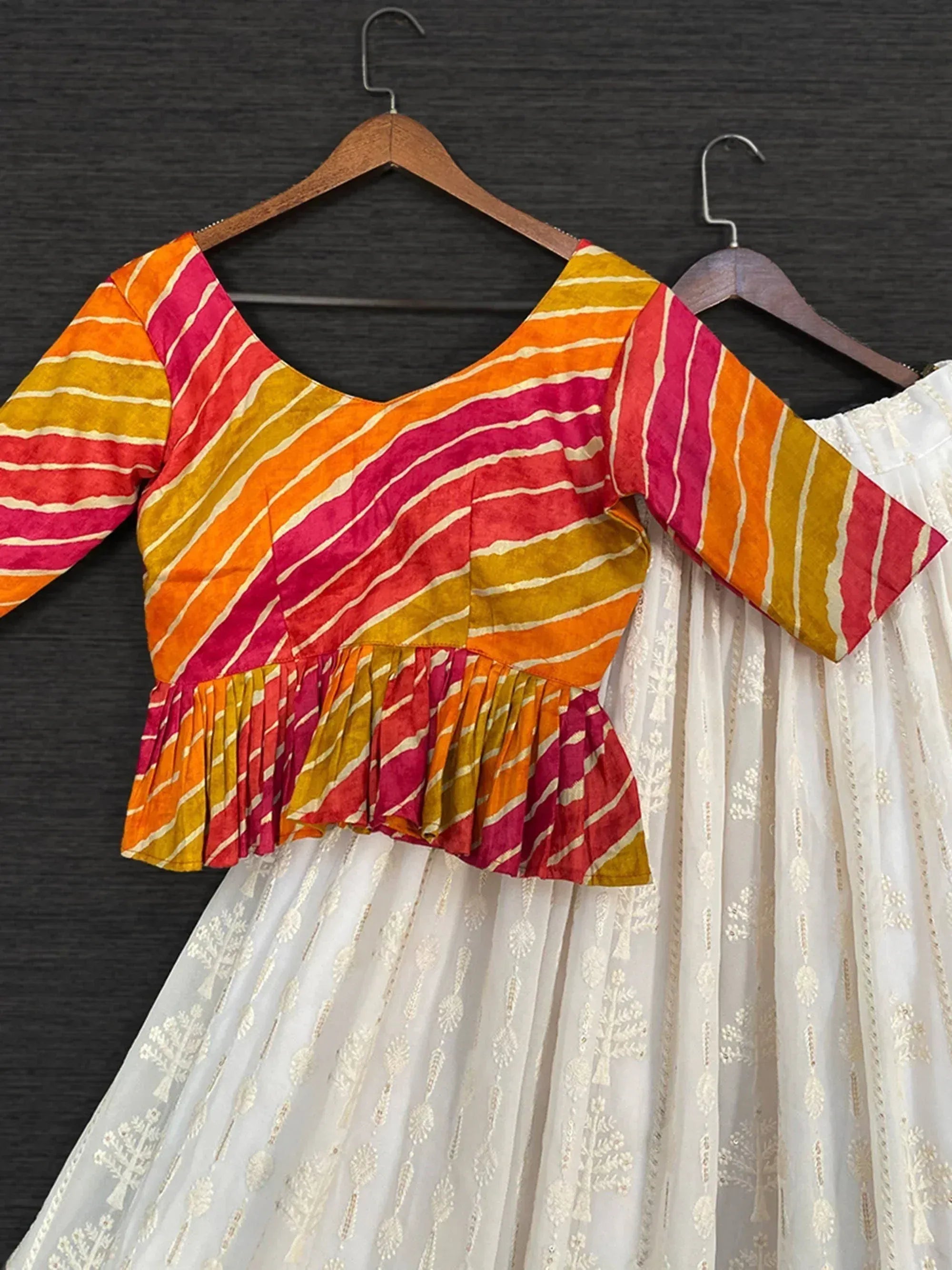 Colorful striped ethnic blouse with white embroidered skirt, perfect for Indian wear