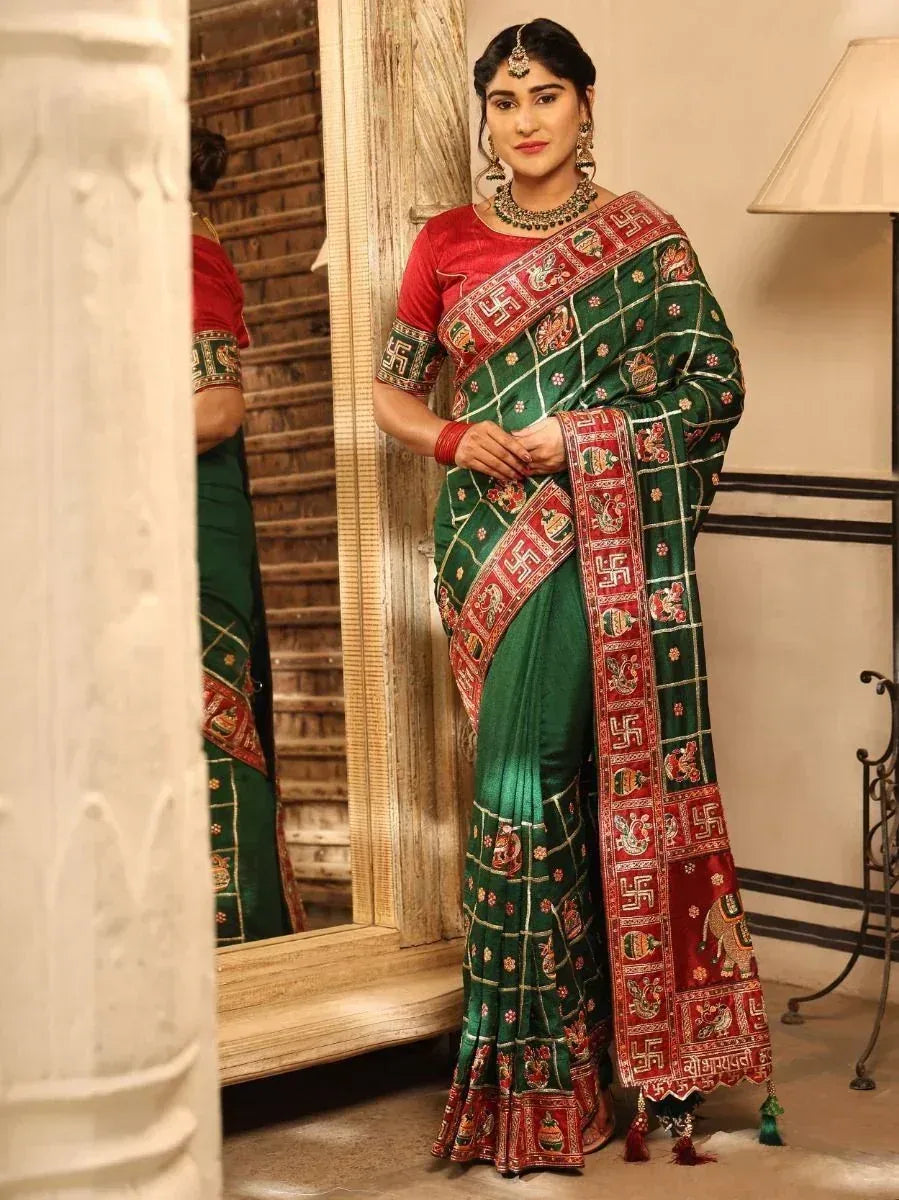 Green and red embroidered saree with traditional Indian motifs and border designs