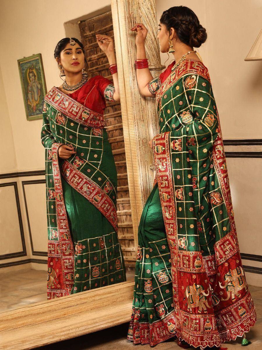 Green and red designer saree with intricate embroidery and traditional motifs, perfect for ethnic occasions.