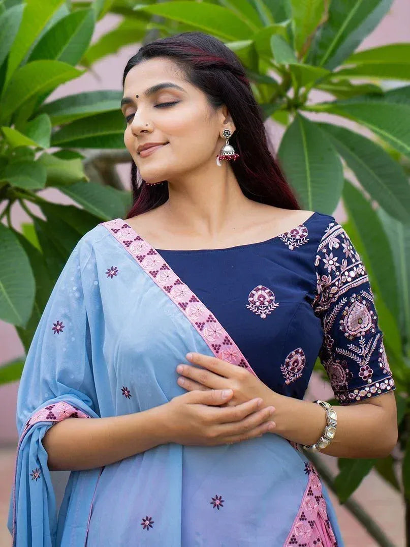 Woman in blue embroidered salwar kameez with pink dupatta, traditional Indian ethnic wear