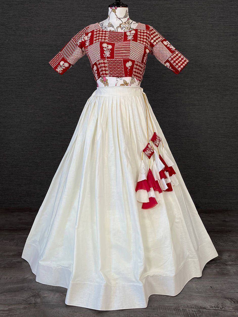 Red and white patchwork ethnic gown with flared skirt and tassel details, perfect for Indian occasions