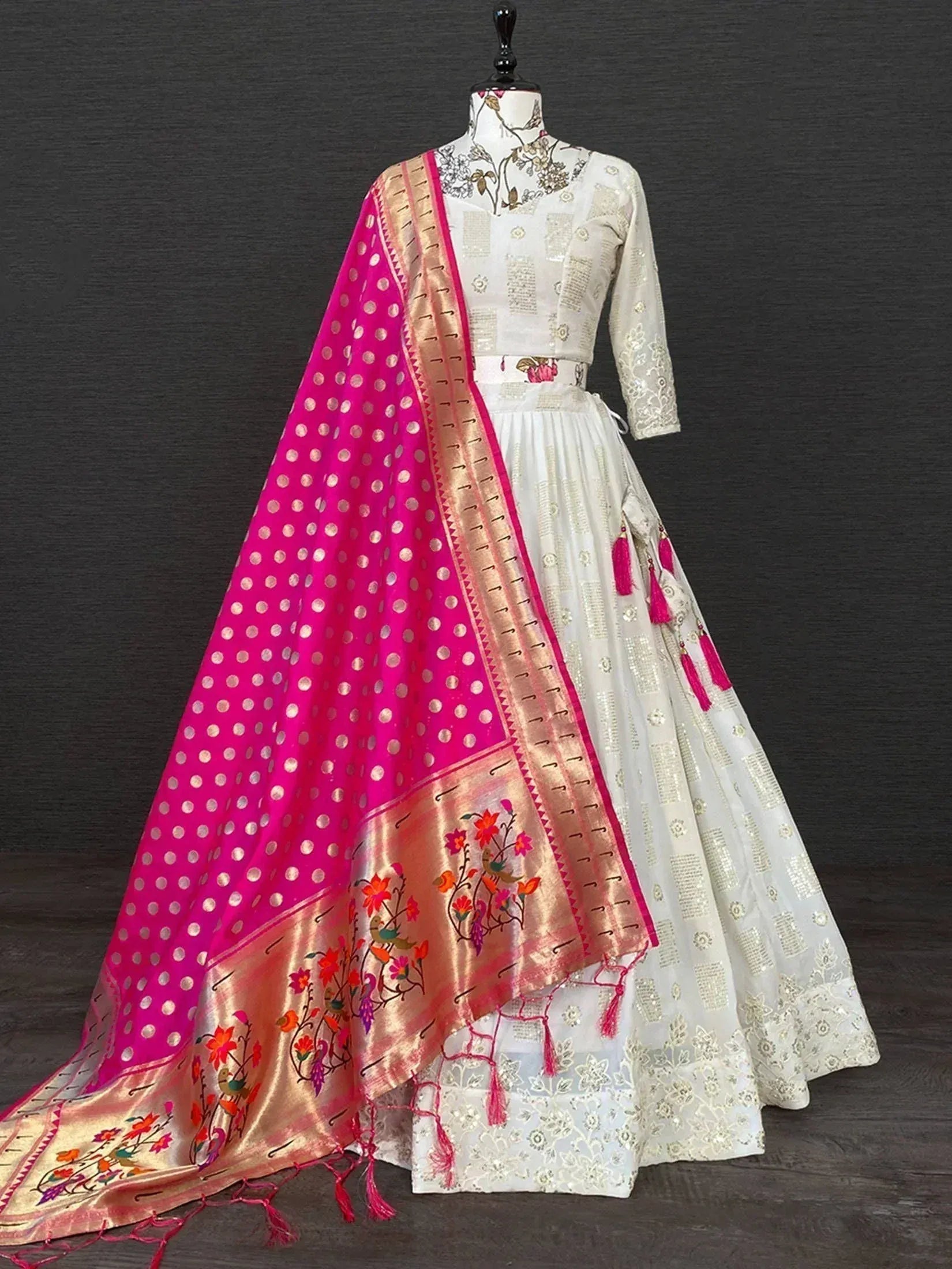 White embroidered lehenga choli with pink polka dot dupatta, floral motifs, and tassels for ethnic wear