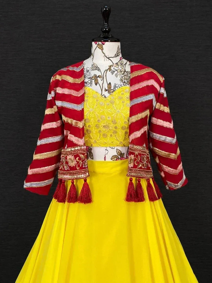 Yellow embroidered lehenga choli with red striped jacket and tassels, Indian ethnic wear
