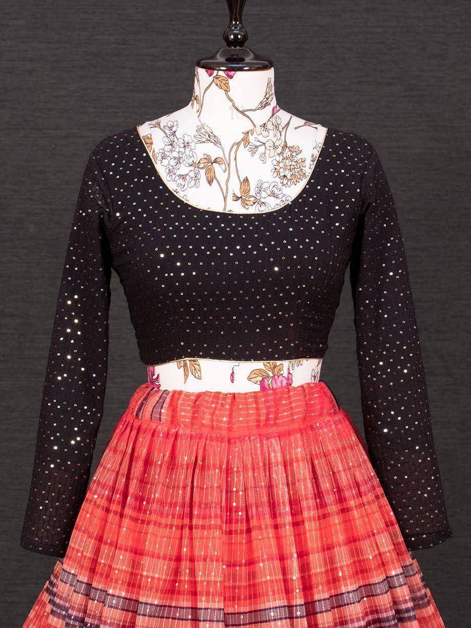 Black sequin top with floral collar paired with red plaid pleated skirt, ethnic wear outfit