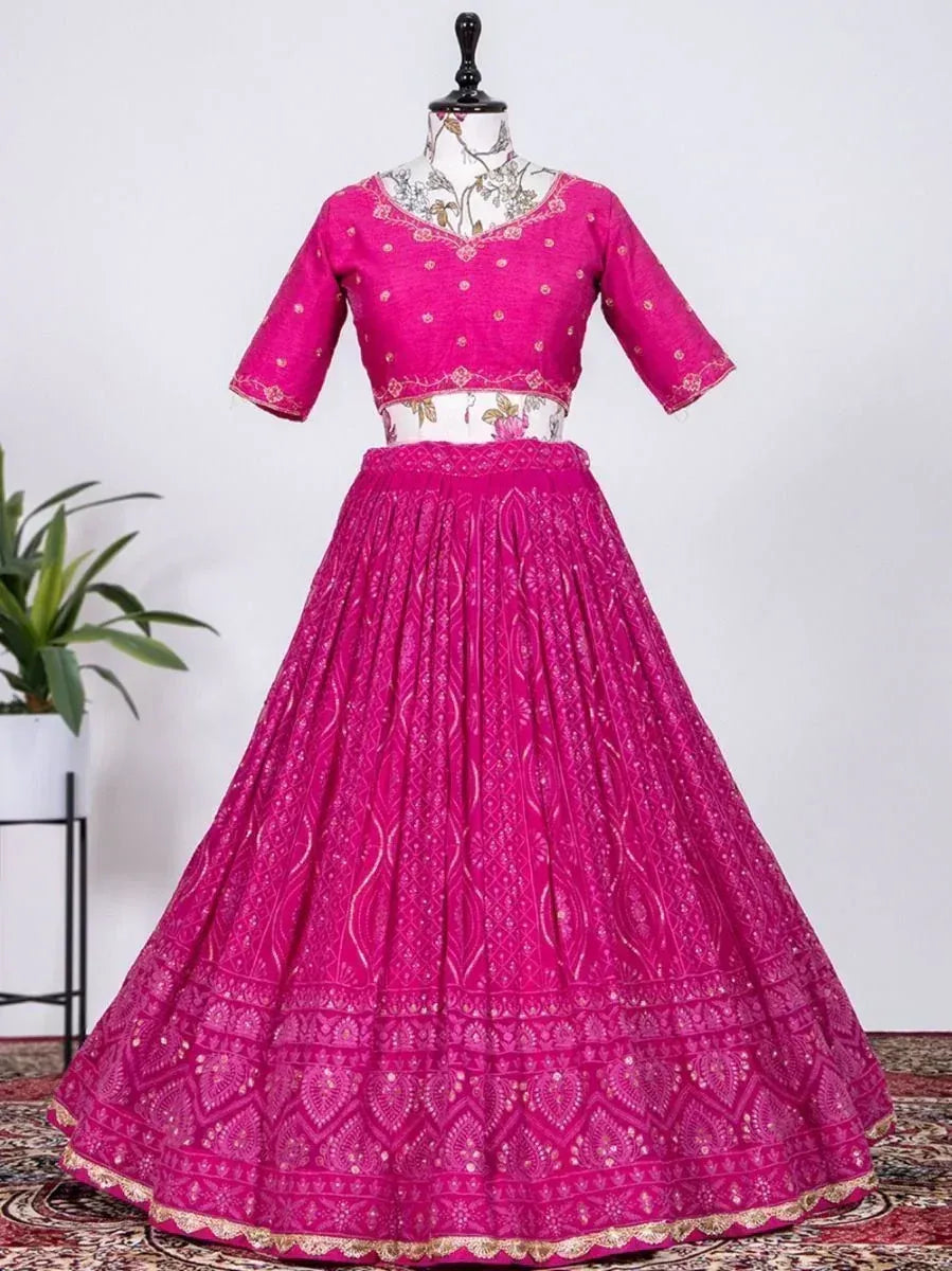 Fuchsia pink embroidered lehenga choli with gold detailing, perfect for Indian ethnic occasions