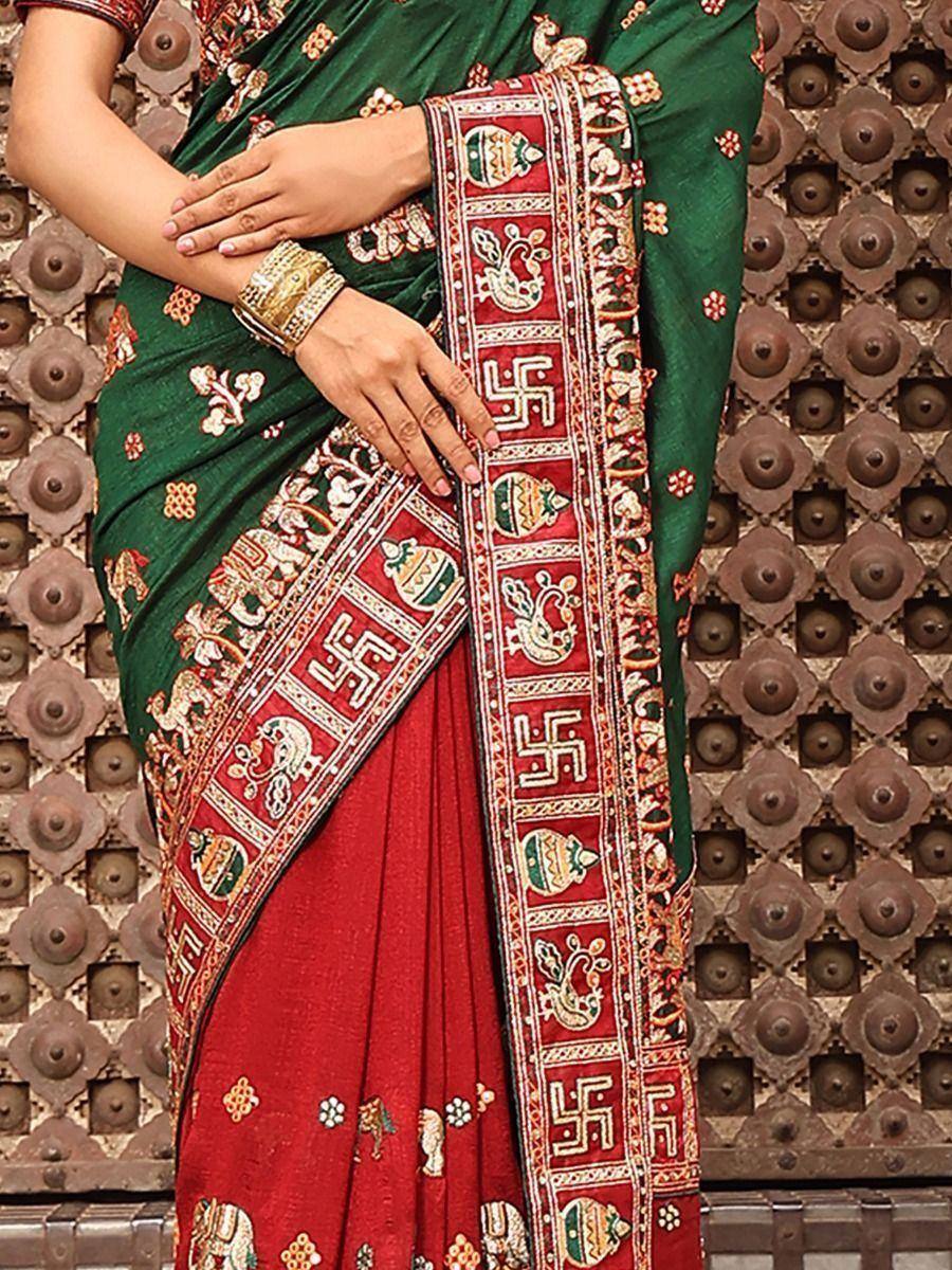 Green and red ethnic saree with intricate embroidery and traditional motifs