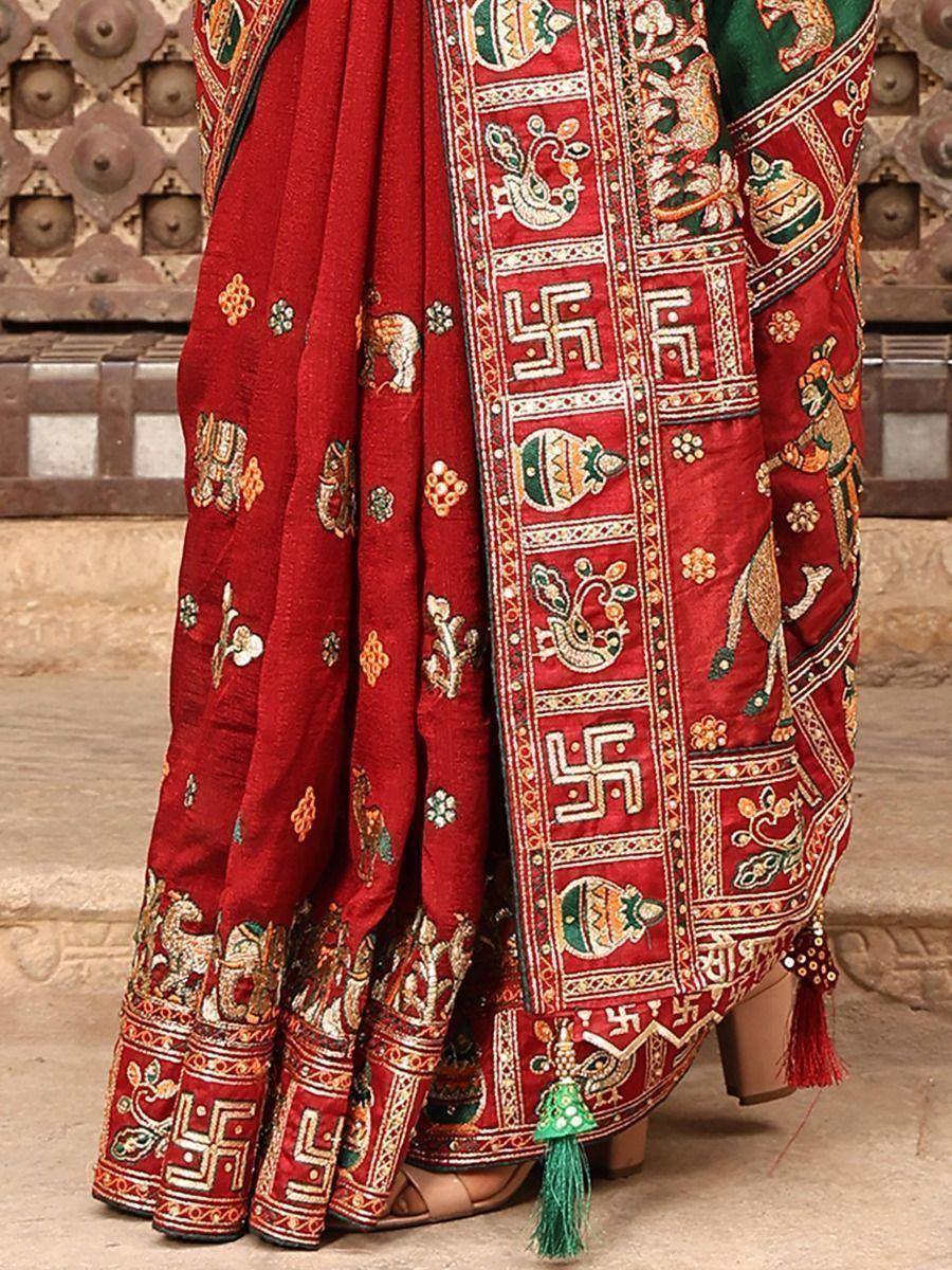 Red embroidered saree with elephant and swastika motifs, traditional Indian ethnic wear