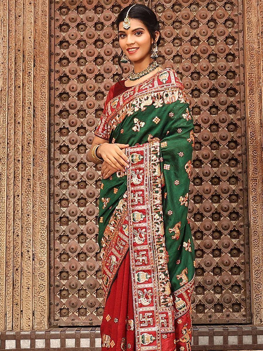 Green and red embroidered saree with traditional Indian motifs and jewelry