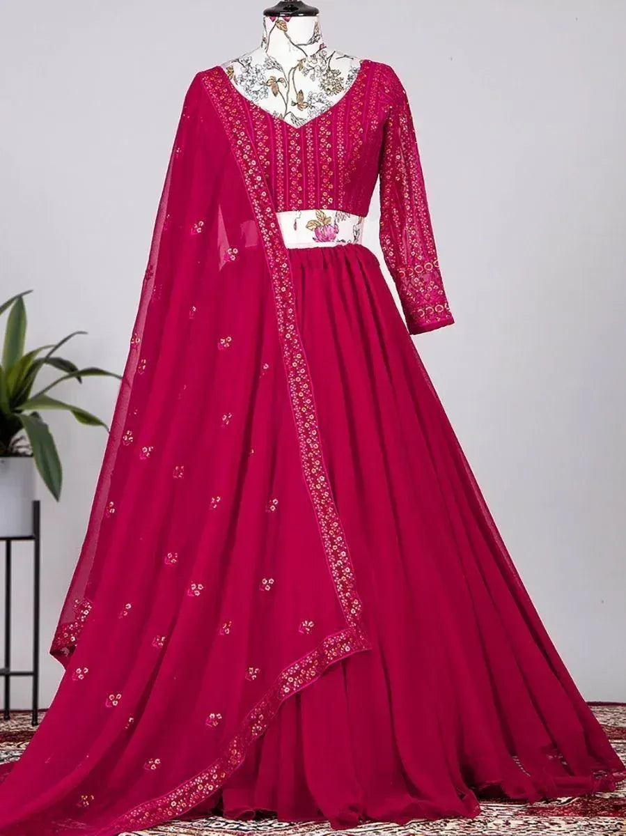 Magenta ethnic gown with floral embroidery and sheer dupatta, perfect for Indian weddings and festive occasions