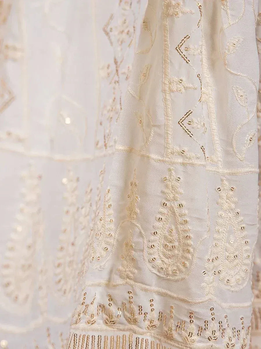 Cream ethnic gown with gold embroidery and sequin detailing, perfect for Indian festive wear